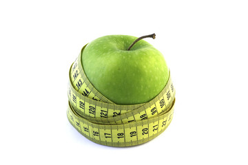 Green apple with measuring tape
