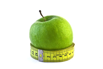 Green apple with measuring tape