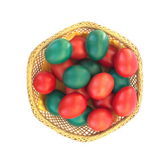 Colored Easter eggs in straw plate isolated on white