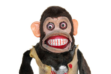 Damaged mechanical chimp with ripped vest, uneven eyes