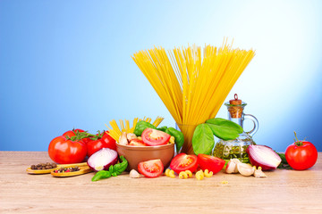 spaghetti with garlic, onion, spices  and basil on a yellow back