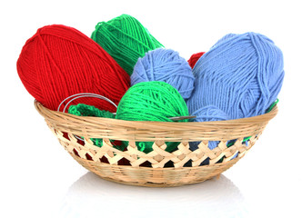 Balls of color knitting wool or yarn in basket on white