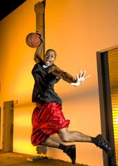 Basketball player jumps with ball © tomalu