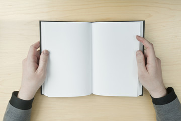 Man reading a blank book