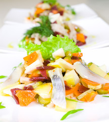 salad of beetroot, carrot, potato, green leek and herring