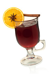 Hot mulled wine with orange slice, anise and cinnamon