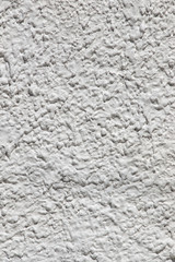 Vertical closeup of white plaster textured wall background