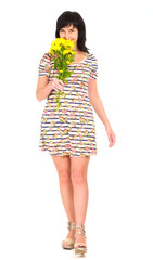 Woman walking in summer dress with yellow flowers
