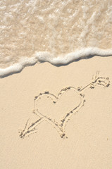 Heart with Arrow Drawn in Sand on Beach