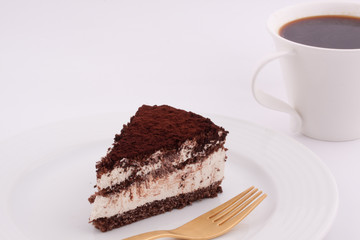 a slice of tiramisu cake and a cup of coffee