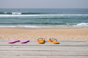 Two pairs of sandals on the beach