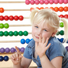 Cute blond child using an abacus to count