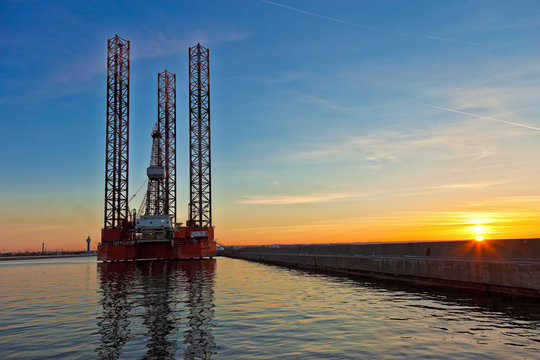 Oil rig at sunset background.