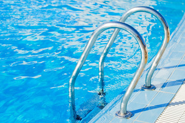 Ladder in pool with a handrail