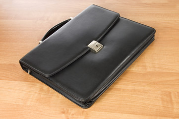 Fashionable leather briefcase on a table