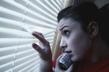 Teenage Girl On The Phone, Looking Out The Window - obrazy, fototapety, plakaty