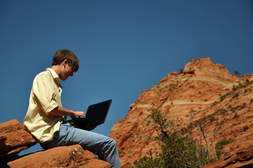 Teenage boy with laptop in zion