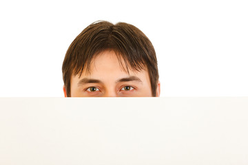 Man's head looking out from blank billboard isolated on white.