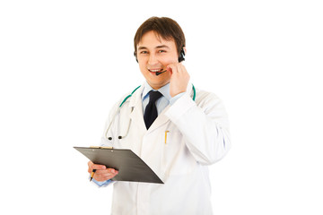 Smiling medical doctor with headset holding clipboard