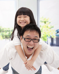 happy asian family. father and little girl
