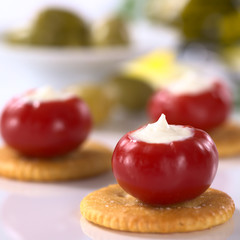 Small round hot red pepper filled with sour cream