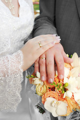 Wedding: hands, rings and bouquet