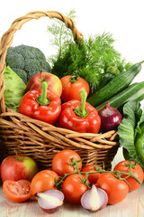 Composition with variety o fresh vegetables in wicker basket