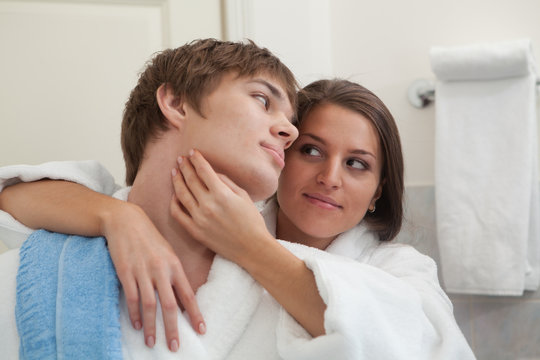 Young happy couple in a bathroom.