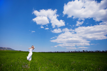 young happy woman in green field