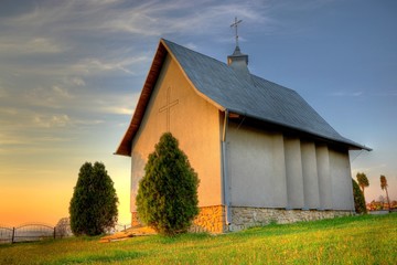 Small catholic chapel on a cementery at warm evening light