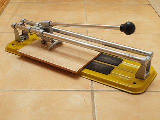 Construction works- ceramic tile cutter with tile.