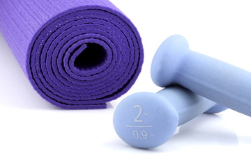 set of women dumbbell weights and yoga mat