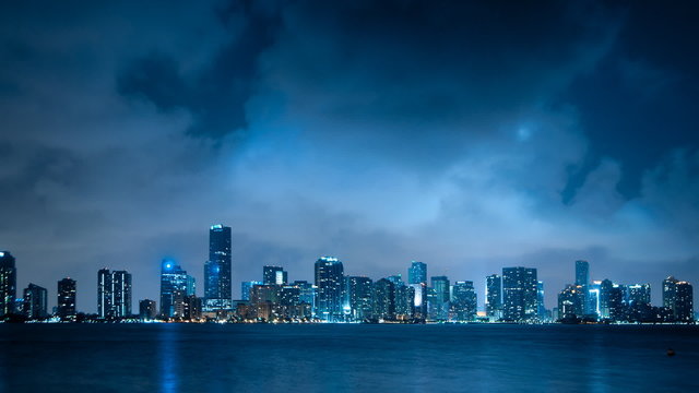 Time lapse of Miami skyline at night with clouds passing by