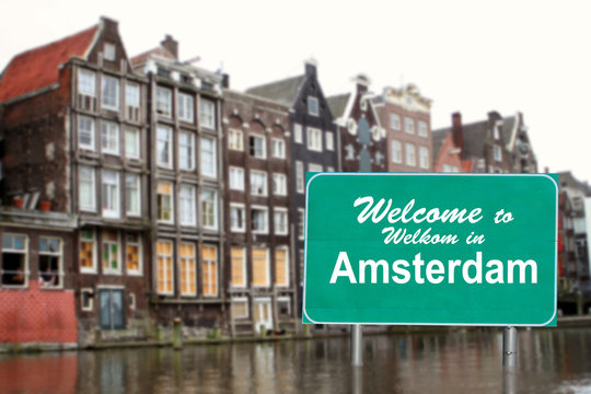 Welcome to Amsterdam sign in water
