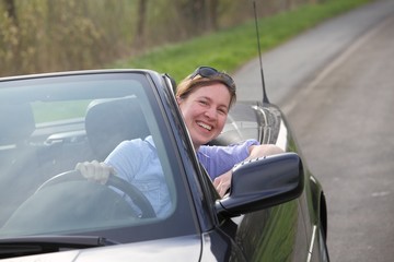 Junge Frau fährt in ihrem Cabrio