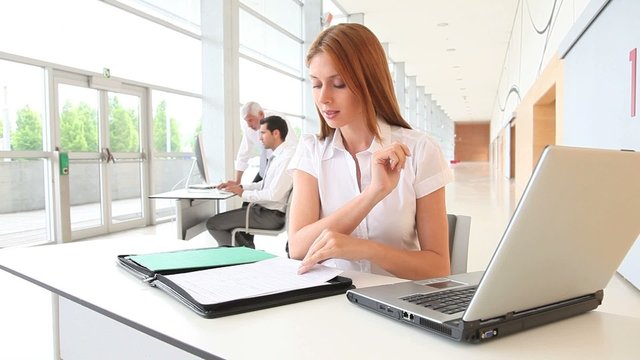 Woman in office working on laptop computer