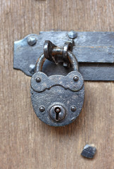 Ancient padlock at a wooden door