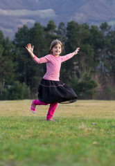 happy little girl running on field
