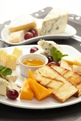 Cheese plate with grapes and honey
