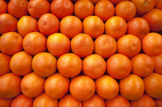 Stacked fresh oranges as a background image