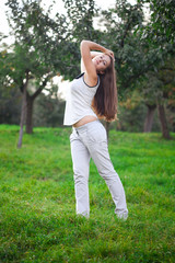 beautiful young woman standing on green grass