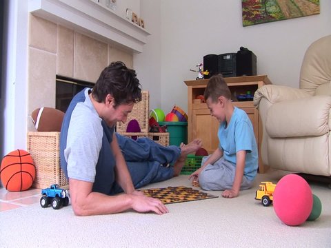 Father and son playing checkers