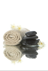 spa rocks and rolled towel