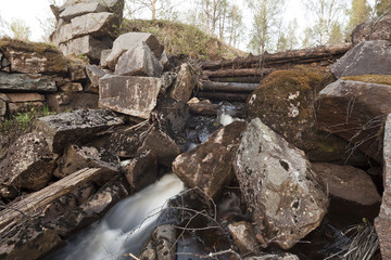 Creek running through wooden damming