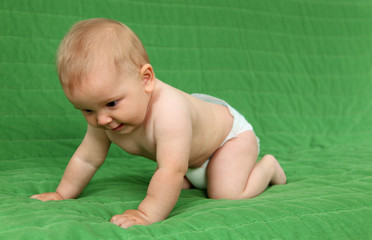 Cute baby girl crawling on the couch