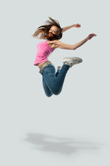 Obraz premium girl in headphones jumps