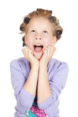 Little girl with hair curlers isolated on white