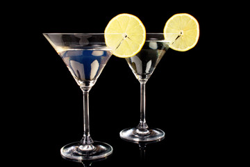 Martini glasses on black background