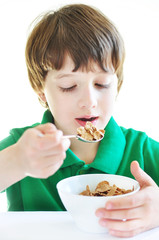 Smiling boy eating his cereal