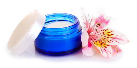 Cream and flower isolated on white